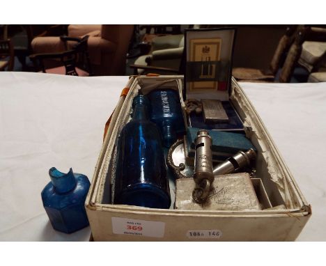 A mixed selection to include police whistle, three vintage blue bottles, Dunhill lighter, costume jewellery etc