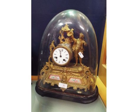 A Regency style French gilt figural clock surmounted with a young male, the central enamel dial with Roman numerals over a pa