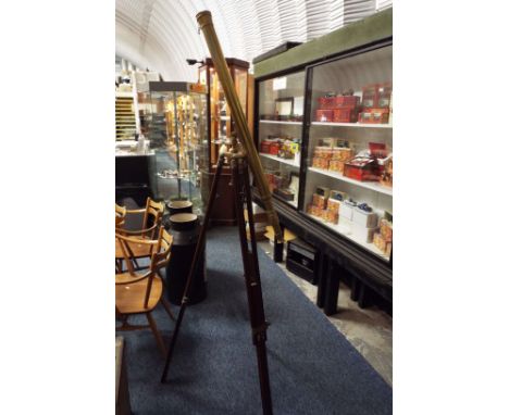 A reproduction brass telescope on a telescopic mahogany tripod stand 