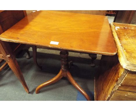 An early 19thC walnut tilt top table, the rectangular top with rounded corners, raised on a turned support and tripod base