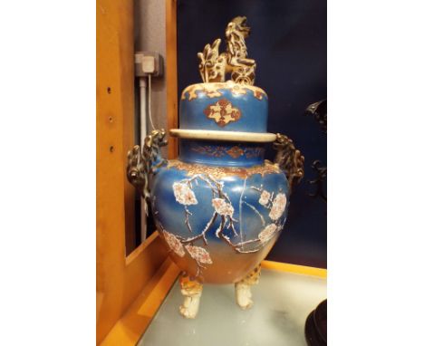 A 19thC Oriental censor the body having prunus decoration applied lion handles resting on masked feet and dog of fo finial