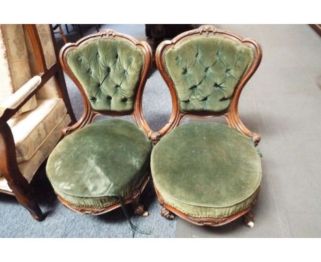 A pair of French mahogany framed parlour chairs having shield scrolled and button back, in green upholstery resting on four k