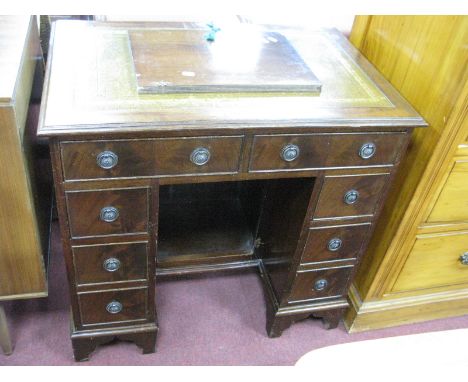 Small Mahogany Kneehole Desk with Tool Scriver Top, two upper drawers over two banks of three drawers on bracket feet, 77cm w