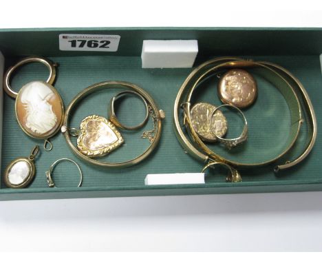 A Wide Bangle, with Part Foliate Design, stamped ''Ecalibur Made In England Rolled Gold'', two similar bangles, stamped ''9ct
