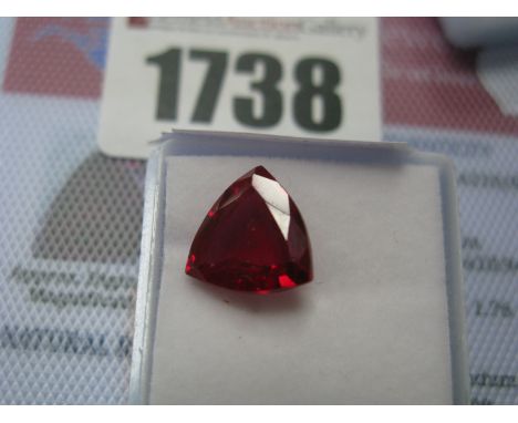 A Trillion Cut Ruby, unmounted with a Global Gems Lab Certificate card stating carat weight 6.60 (Treatments: Heating).