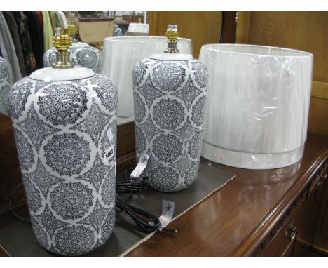 A Pair of Ceramic Table Lamps, with black symmetrical designs on white ground.