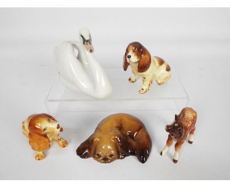 Four animal figures comprising two W R Midwinter dogs, a Beswick calf and a Royal Copenhagen swan # 755, largest approximatel