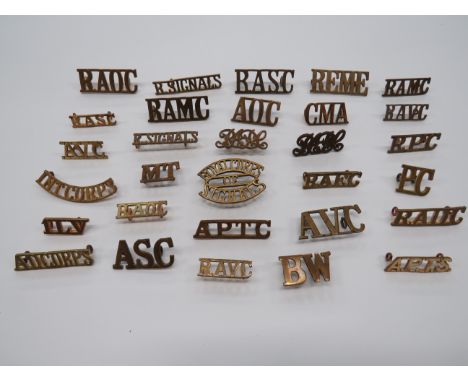 Selection of Corps Shoulder Titles  brass titles include REME ... CMA ... Int Corps ... APTS ... PC ... RPC ... A D Corps ...