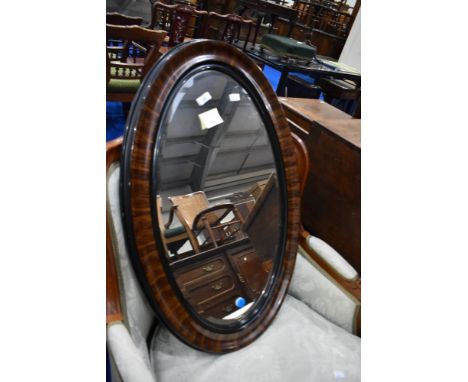 A vintage grain effect oval wall mirror, approx 83 x 54cm