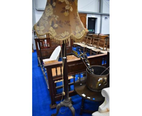 An early 20th Century mahogany standard lamp having trefoil base with paw feet