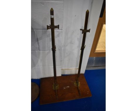 An ecclesiastical style pine shelf having brass supports