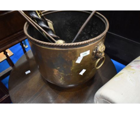 A brass coal bucket and selection of fire tools