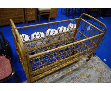 A vintage wicker cot, dimensions approx L132cm W60cm H91cm