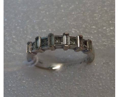 An 18 carat white gold and diamond half-hoop ring, composed of alternating baguette and princess cut diamonds.
