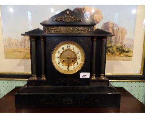 A Victorian slate mantle clock, the circular enamel dial bearing Arabic numerals (38cm tall).
