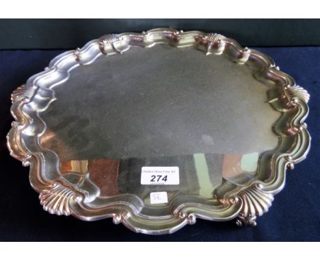 Goldsmith & Silversmith Company, London 1918, a large silver salver, scalloped edged rim on three supports (37.5cm diameter),