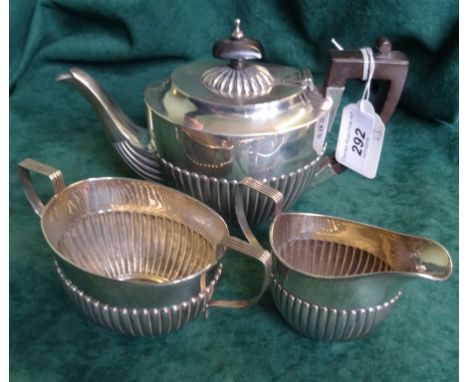 A late Victorian silver three piece bachelor's tea set, comprising: teapot, twin handled sugar bowl and cream jug, Birmingham