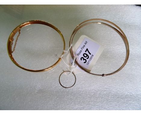 A three coloured gold bangle, together with a yellow metal bangle and a 9 carat three coloured gold ring.