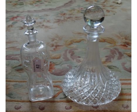 A 19th century glass decanter of pinched body form, together with a glass ship's decanter (the tallest 27cm).