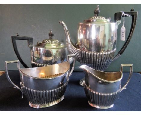 An Edwardian silver plated four piece tea set, comprising: teapot, hot water jug, twin handled open sugar bowl and cream jug.