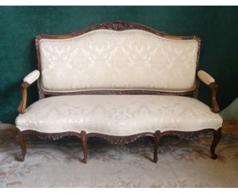 A Victorian carved three seater sofa (168cm wide).