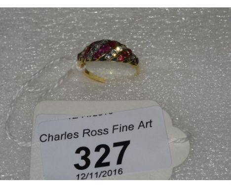 An 18 carat yellow gold ring, set with alternating diagonal lines of rubies and diamonds. Condition Report: Age not known.
We