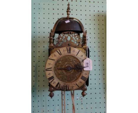 A brass wall hanging lantern clock with weight, the circular dial bearing Roman numerals (40cm). Condition Report: Pendulum a