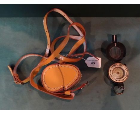 A leather cased WWII military compass, stamped E.A.C no. B13303, 1943 MKIII.
