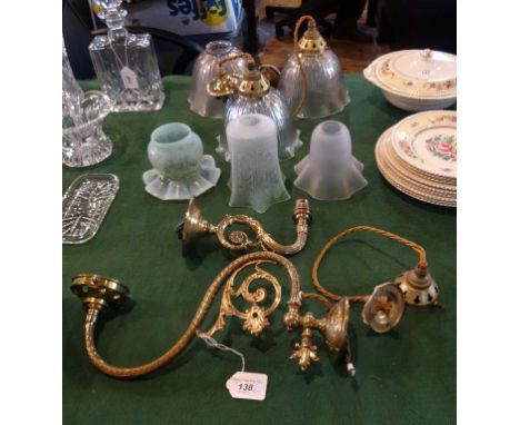 Two brass wall light fittings, together with a collection of glass lampshades.