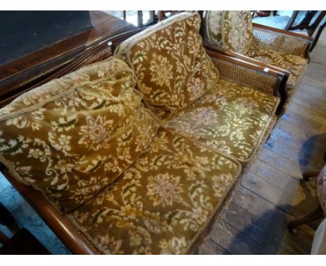 A mid-20th century single cane three piece bergere suite, comprising two seater sofa and two armchairs.