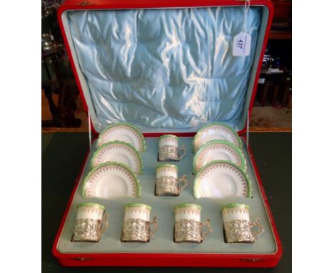 An early 20th century cased Ainsley china coffee set, a six place setting, comprising coffee cans and saucers with gilt and g