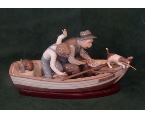 A Lladro 5215 'Fishing With Gramps', figure group in a rowing boat named Paloma (39cm long) on conforming wooden stand.