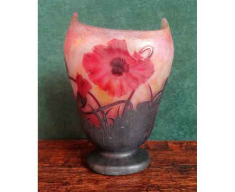 A large Daum Nancy pedestal vase of high-shouldered form, with acid etched mauve poppy flowers and leaves on a mottled red an