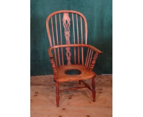 A Windsor hoop-back armchair, later converted to a commode (58cm wide).