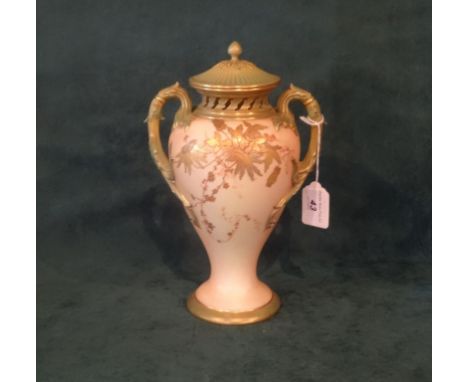 A late Victorian Royal Worcester twin handled blush ivory covered vase, decorated in gilt and painted flowers, shape no. 1927