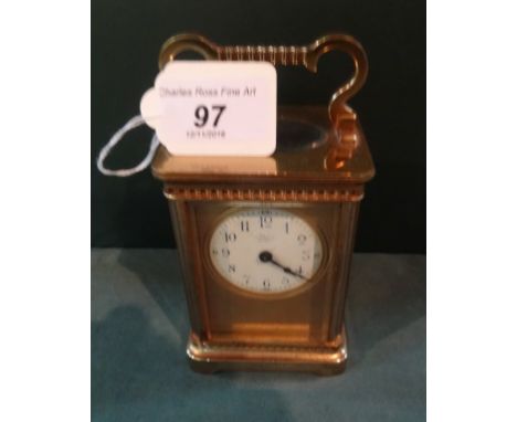 A French gilt brass carriage clock, single barrel movement, the five panels fitted with bevelled edge glass, the gilt engine 