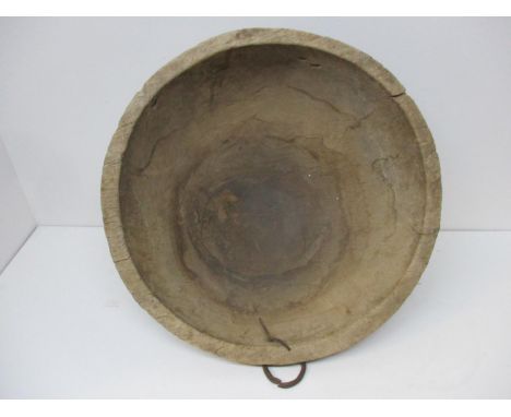A late 19th/early 20th century Sudan carved wooden food bowl with an iron split ring handle, 21 1/2"dia 