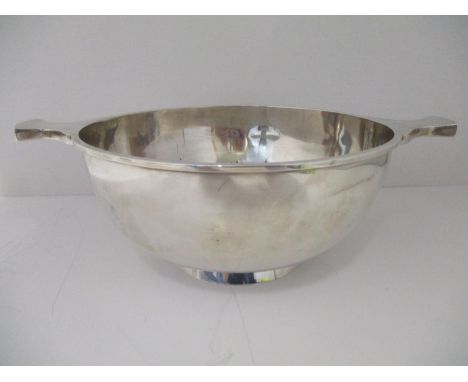 A large silver porringer, by Mackay &amp; Chisholm Edinburgh 1938 with twin waisted handles and a convex central boss, on a f