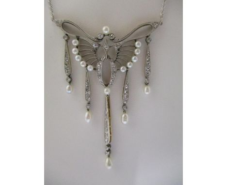 A yellow metal and white metal butterfly pendant necklace set with diamonds and cultured pearl decoration, fitted with a fine
