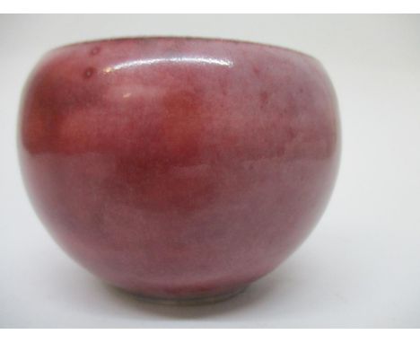 A Kangxi Chinese mark and period bowl of bulbous form, in a red glazed, fading to a pale purple in areas, a blue/white interi