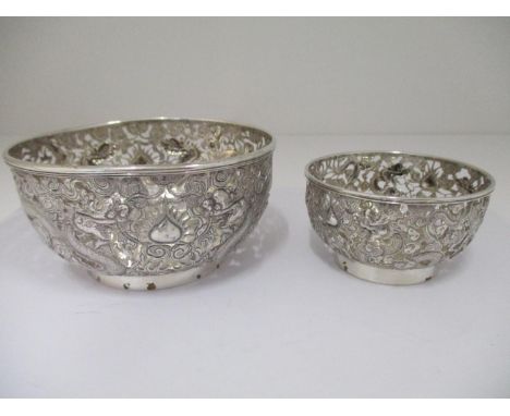 Two late 19th/early 20th century Chinese silver bowls, by HM 1880/1910 , embossed and pierced with dragons and clouds, on a f