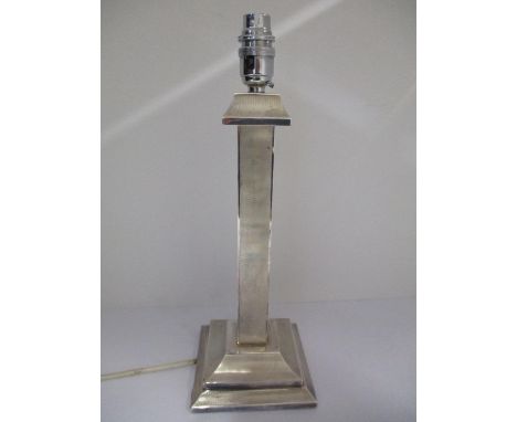 A silver table lamp, London 1937 by British Metallising Co Ltd with a flared top, square column and a flared, stepped, chamfe