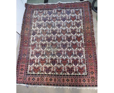 A Caucasian rug with repeated geometric shield and arrow motifs, on a cream ground, 65" x 56" 