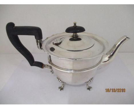 A silver teapot by Henry Wilkinson Sheffield 1928, on four scrolled feet, having ebony handle and finial to lid, 5 1/2" h, to