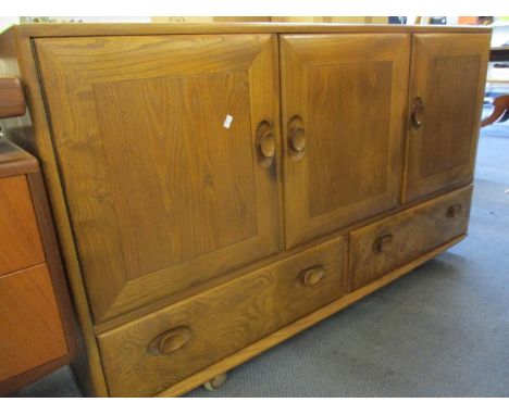 An Ercol light elm sideboard having three cupboard doors above two drawers, 30" x 51" x 17" 