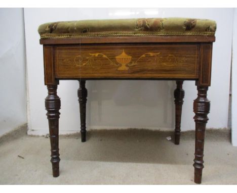 A late Victorian inlaid rosewood music stool with a hinged, upholstered seat, the frieze decorated with urns and scrolled fol