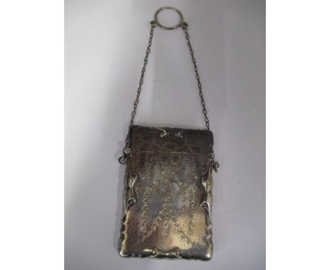 A George V silver card case Chester 1914 by E J Trevitt &amp; Sons, of rectangular form with a hinged lid, embossed with scro