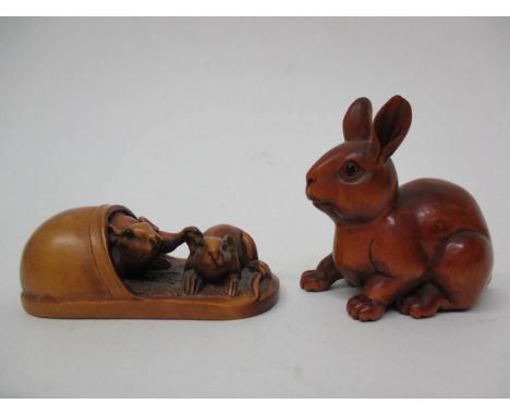 Two Chinese carved wooden netsuke, one in the form of a rabbit with a signature to the base and the other two rats in a shoe 