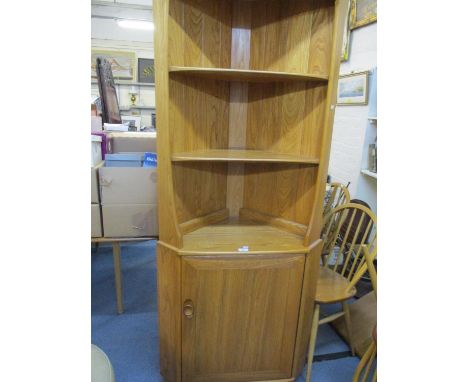 An Ercol corner display unit having two shelves above a single cupboard door 