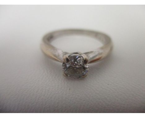An 18ct white gold solitaire diamond ring, approximately 0.15ct on a tapered ring 